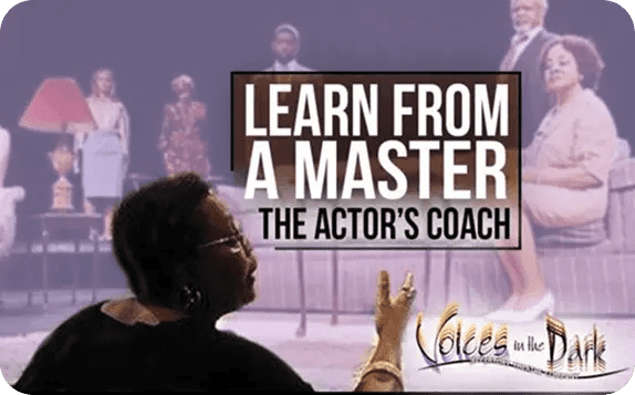 Actor's coach teaching on stage with models in background.
