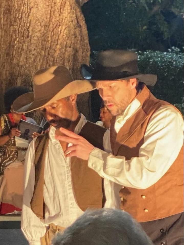Two men in cowboy hats and vests