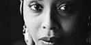 Black-and-white portrait of woman wearing headscarf
